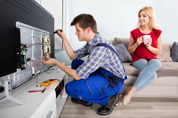 depositphotos 137860252 stock photo technician repairing television at home (3)